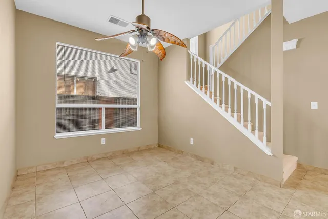 a view of an empty room with staircase