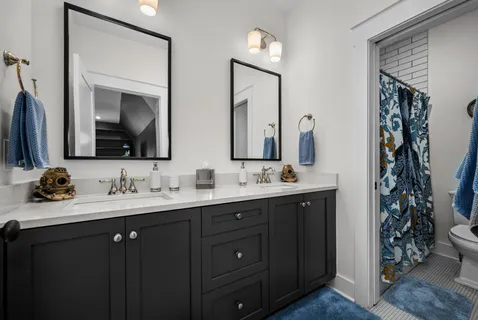 a bathroom with a double vanity sink and a mirror