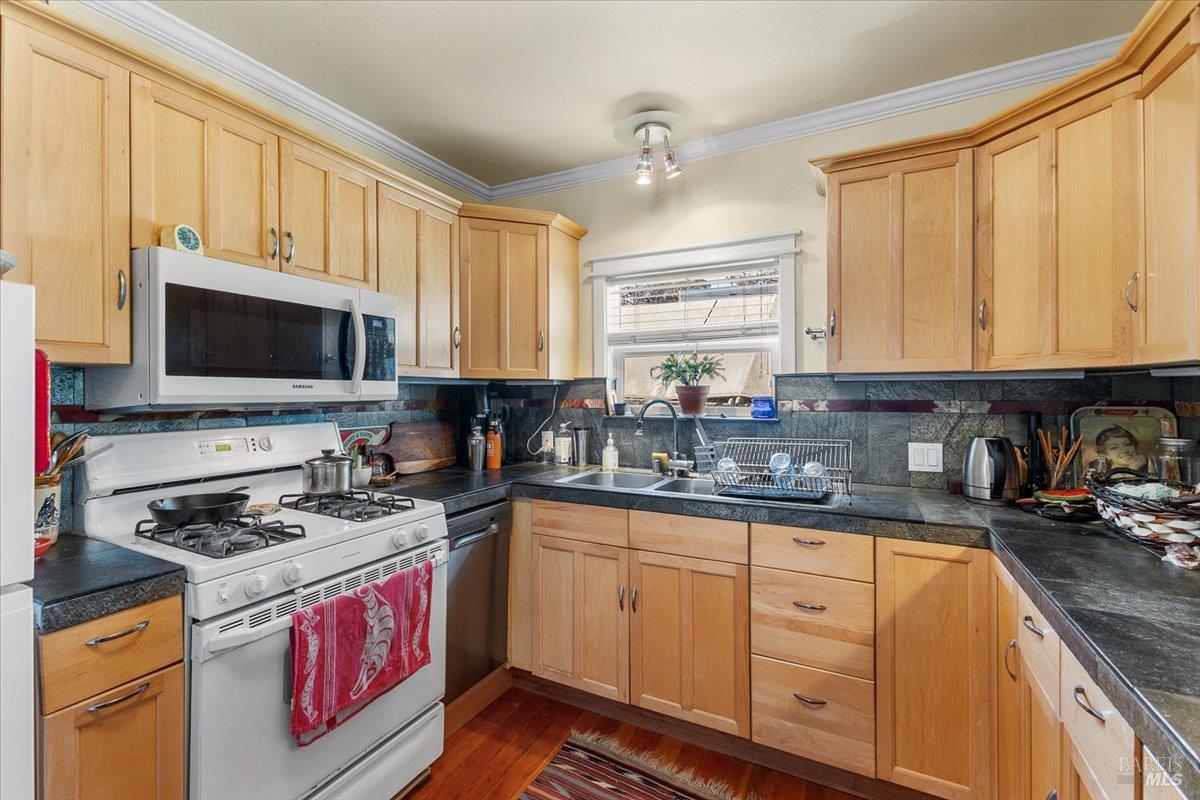 130 11th Street Santa Rosa, CA 95401 - Photo 12 of 50 a kitchen with granite countertop a stove a sink and a microwave