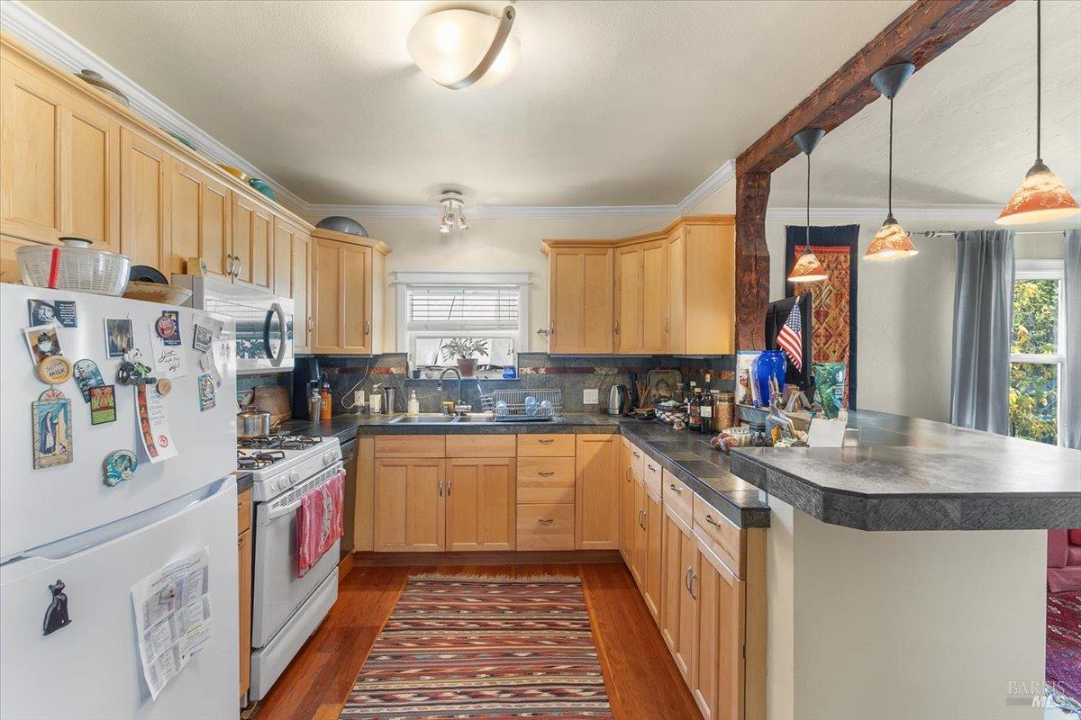 130 11th Street Santa Rosa, CA 95401 - Photo 14 of 50 a kitchen with a sink stove and cabinets