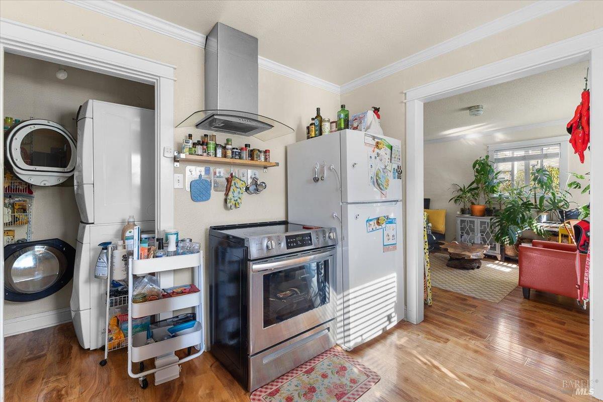 130 11th Street Santa Rosa, CA 95401 - Photo 31 of 50 a kitchen with a refrigerator and wooden floor