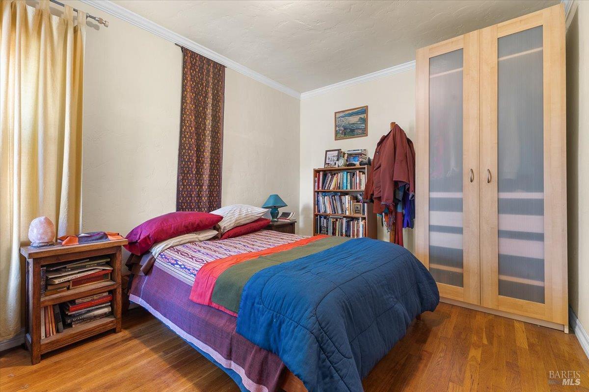 130 11th Street Santa Rosa, CA 95401 - Photo 6 of 50 a bedroom with a bed and a book shelf
