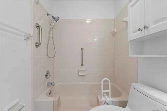 a bathroom with a granite countertop sink a toilet and a large mirror