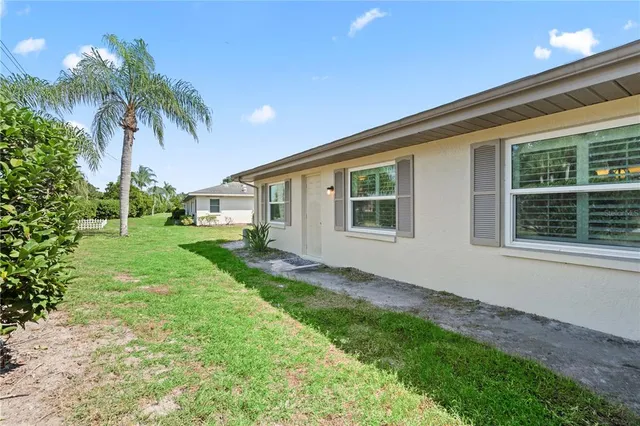 an aerial view of a house with garden space and street view
