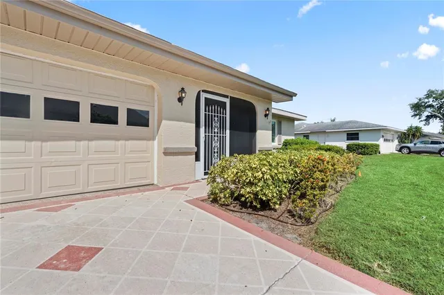 a front view of a house with a garden and patio