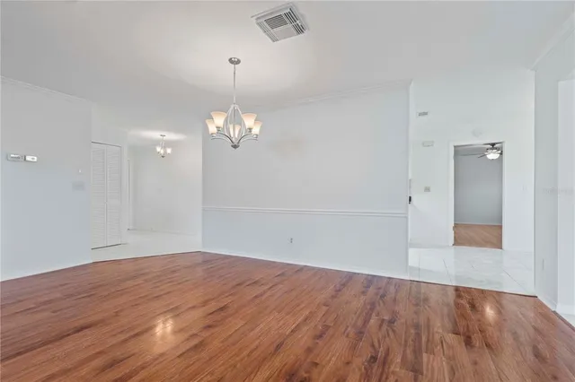 an empty room with wooden floor