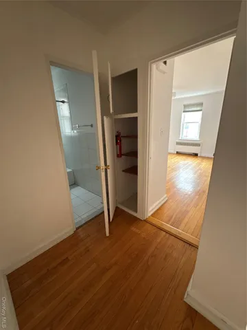 an empty room with wooden floor and closet