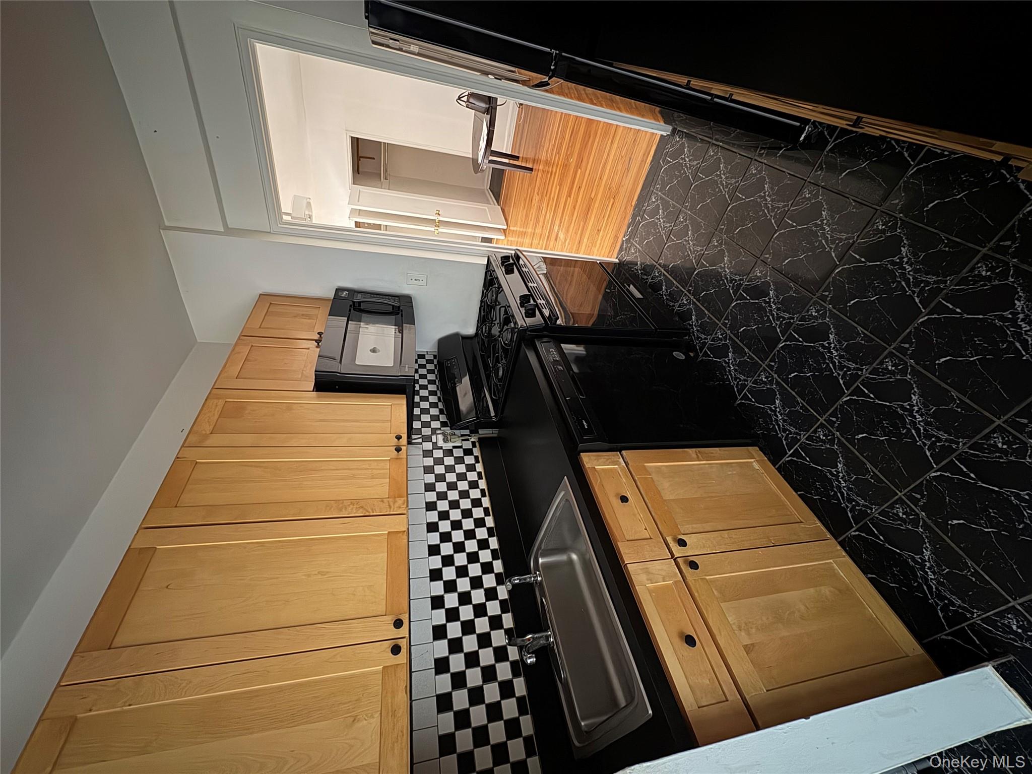 2090 Barnes Avenue, Unit 4D Bronx, NY 10462 - Photo 4 of 14 a kitchen with granite countertop stainless steel appliances a stove a sink and a microwave