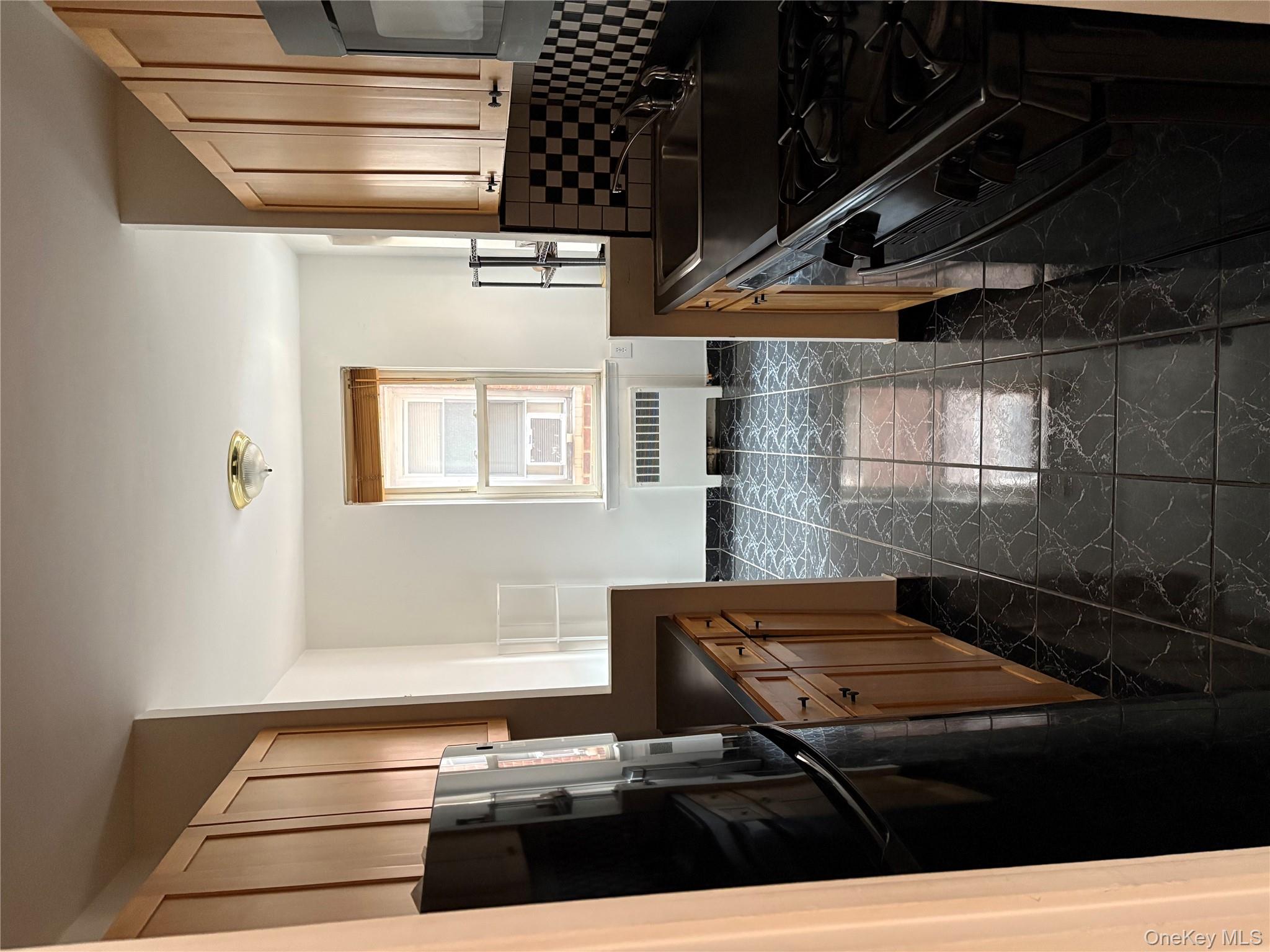 2090 Barnes Avenue, Unit 4D Bronx, NY 10462 - Photo 5 of 14 a kitchen with granite countertop a refrigerator stove and sink