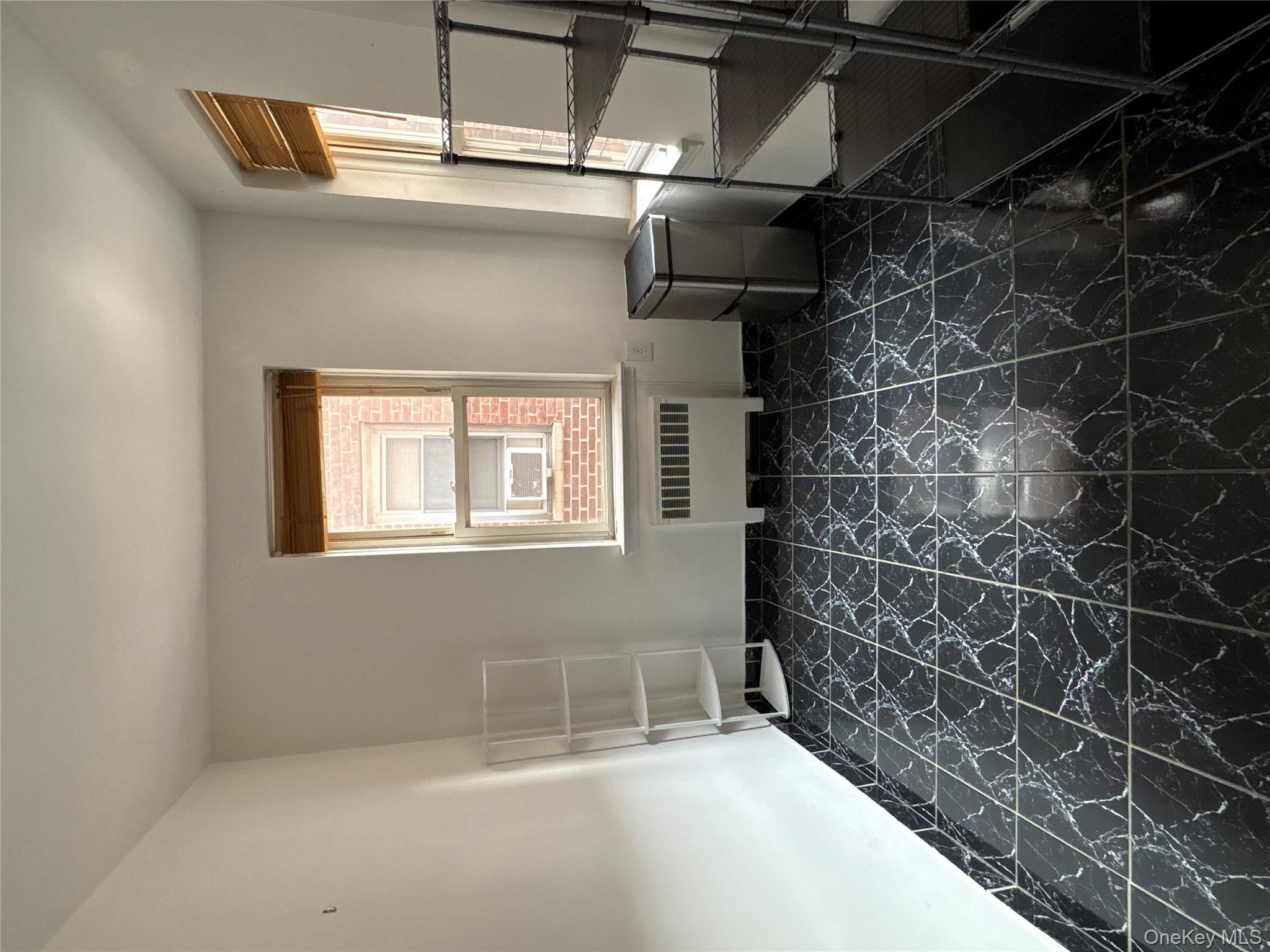 2090 Barnes Avenue, Unit 4D Bronx, NY 10462 - Photo 6 of 14 a room with a rug and a window