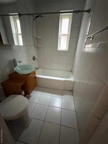 a bathroom with a sink a toilet and bathtub