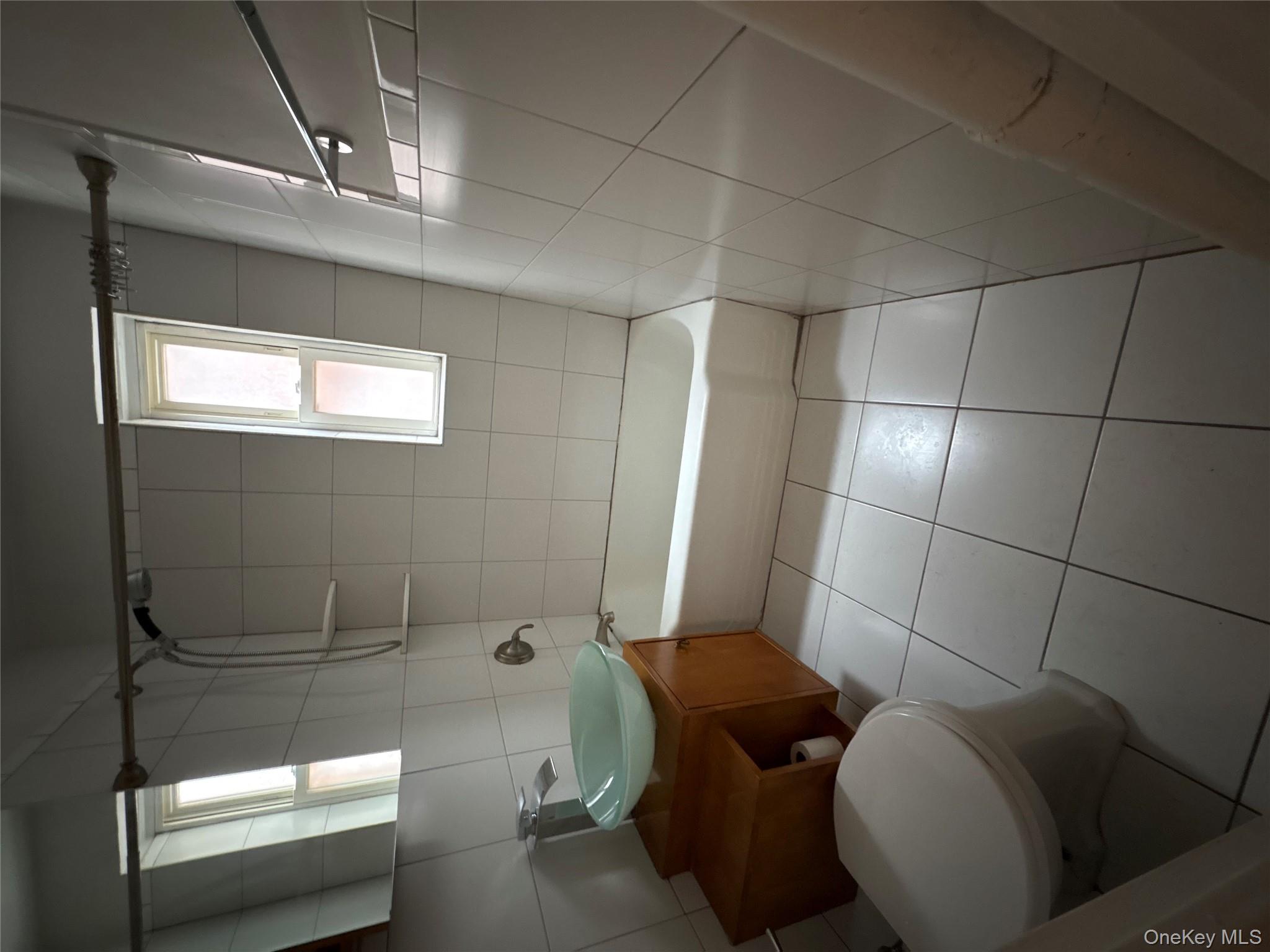 2090 Barnes Avenue, Unit 4D Bronx, NY 10462 - Photo 8 of 14 a bathroom with a sink a toilet and bathtub