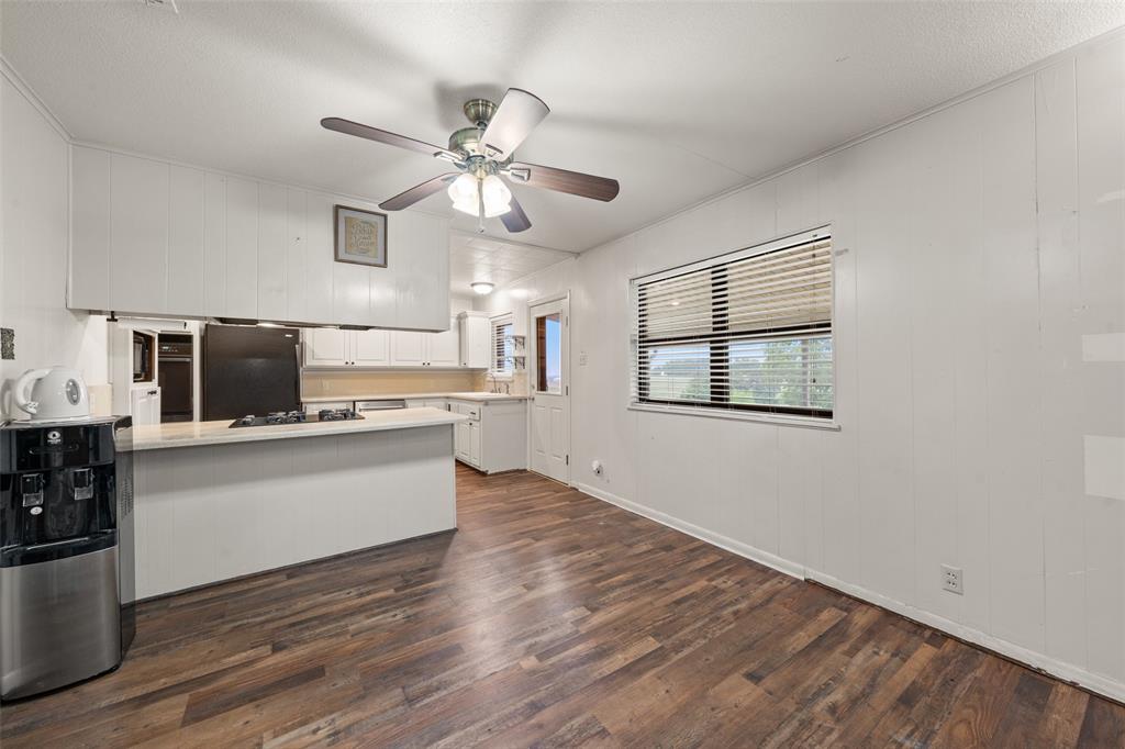 608 West Spring Street West, TX 76691 - Photo 7 of 27 a view of kitchen with wooden floor electronic appliances and window