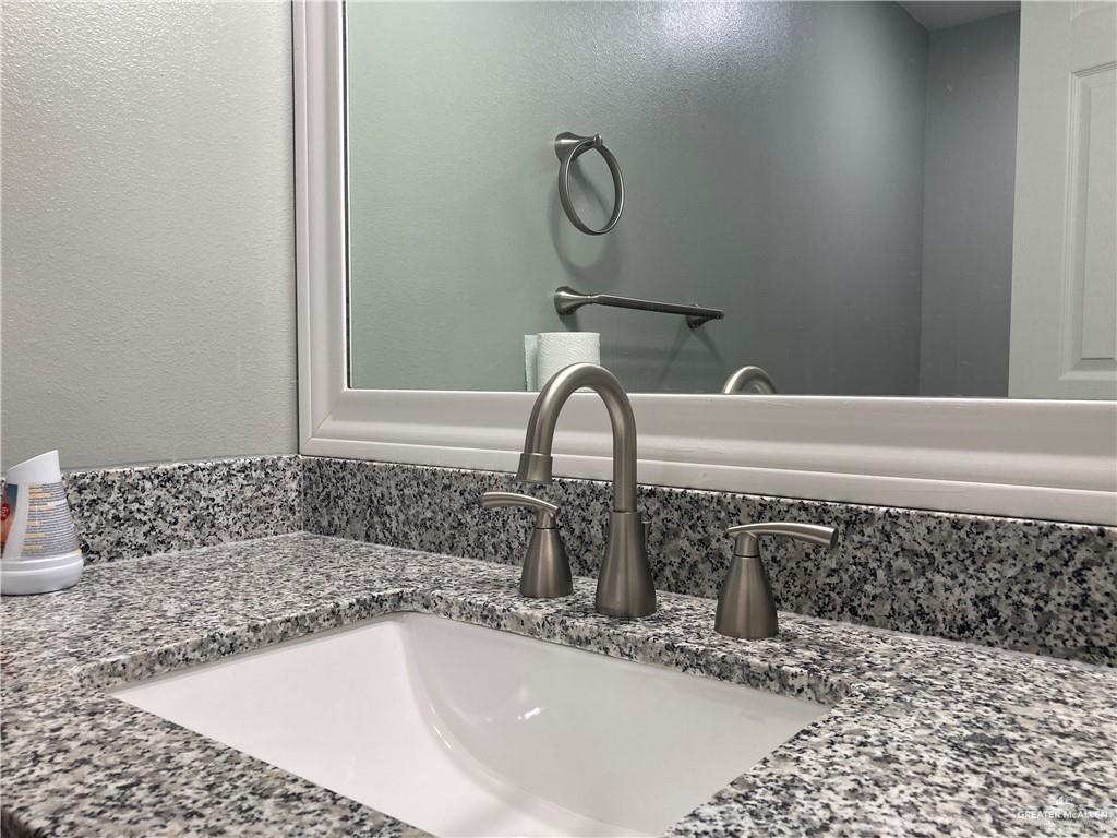 2103 South 6th Street McAllen, TX 78503 - Photo 14 of 33 Bathroom view of a textured wall and vanity