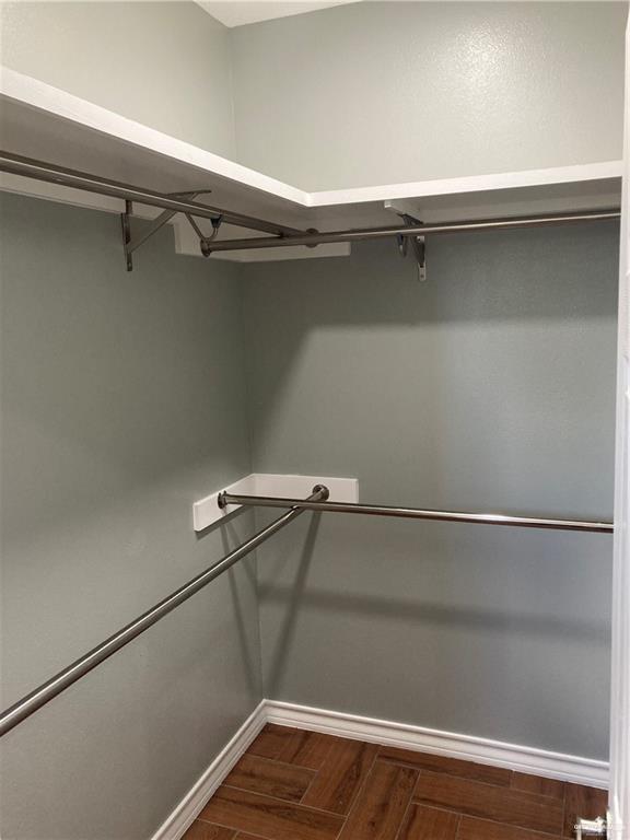 2103 South 6th Street McAllen, TX 78503 - Photo 16 of 33 Walk in closet with dark wood-type flooring
