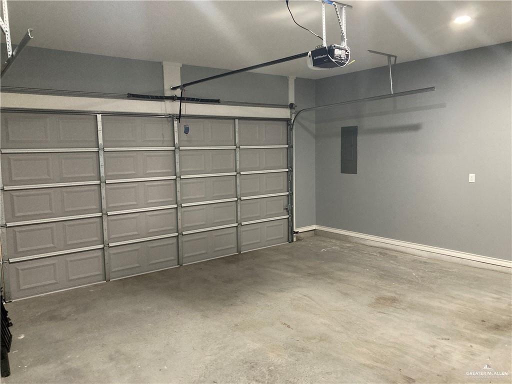 2103 South 6th Street McAllen, TX 78503 - Photo 18 of 33 Garage with electric panel and a garage door opener