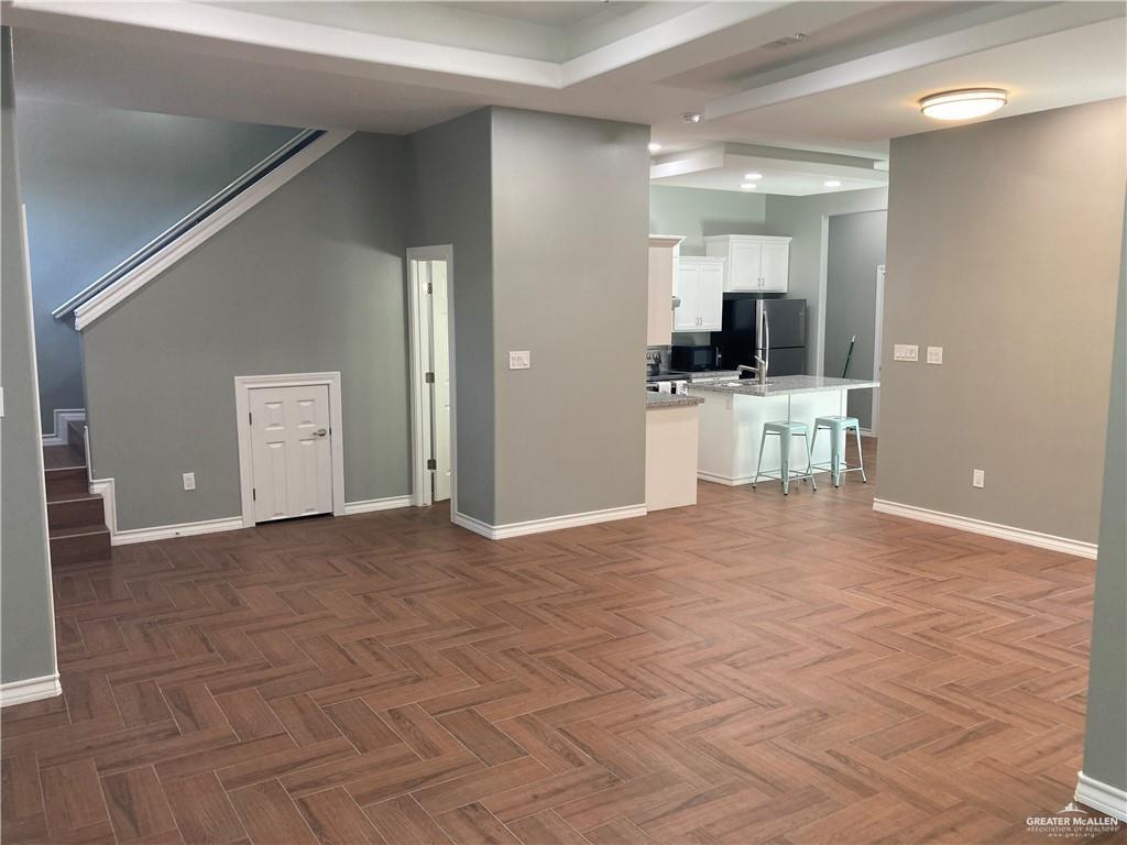 2103 South 6th Street McAllen, TX 78503 - Photo 2 of 33 Unfurnished living room with stairs and baseboards