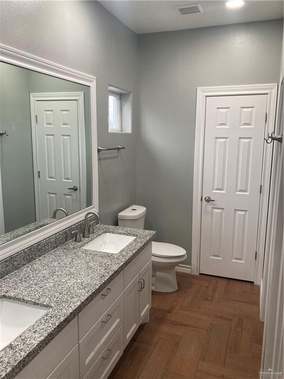 2103 South 6th Street McAllen, TX 78503 - Photo 26 of 33 Full bathroom with double vanity and toilet