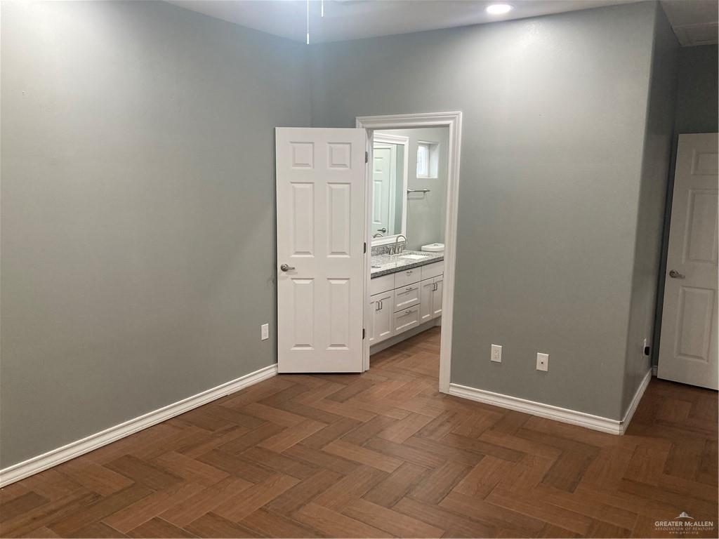 2103 South 6th Street McAllen, TX 78503 - Photo 27 of 33 Unfurnished bedroom featuring ensuite bath and baseboards