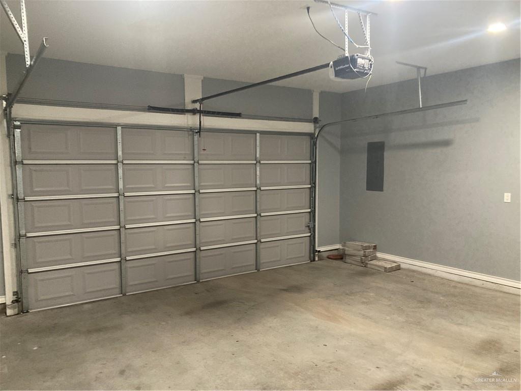 2103 South 6th Street McAllen, TX 78503 - Photo 30 of 33 Garage featuring electric panel and a garage door opener