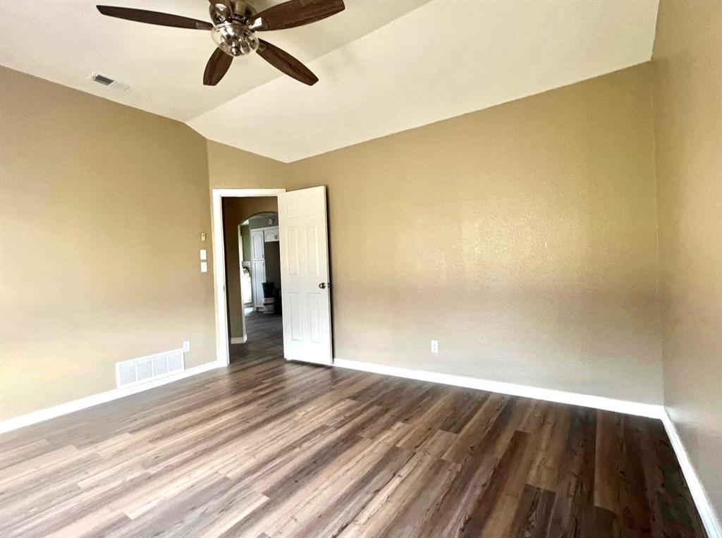 3133 Tbd County Road Lone Oak, TX 75453 - Photo 21 of 21 Vaulted ceiling with a ceiling fan, wood-finish flooring, neutral wall paint, and white trim