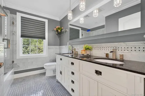 a spacious bathroom with a granite countertop sink and a mirror
