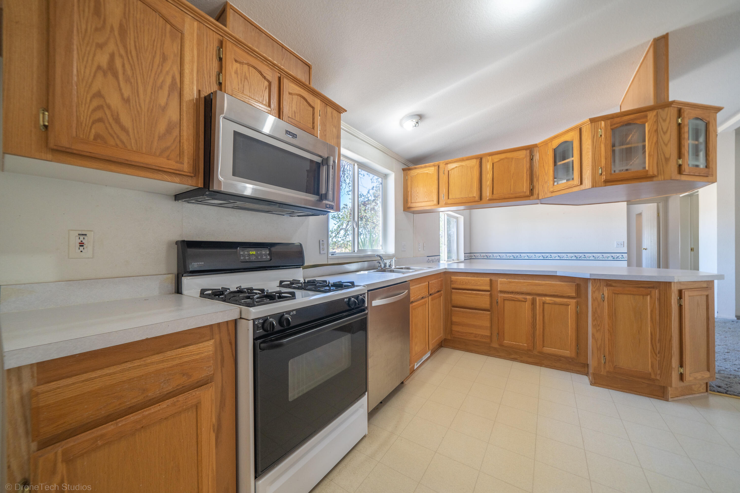 19035 Ridge Road Red Bluff, CA 96080 - Photo 17 of 74 a kitchen with stainless steel appliances granite countertop a stove a sink and a microwave