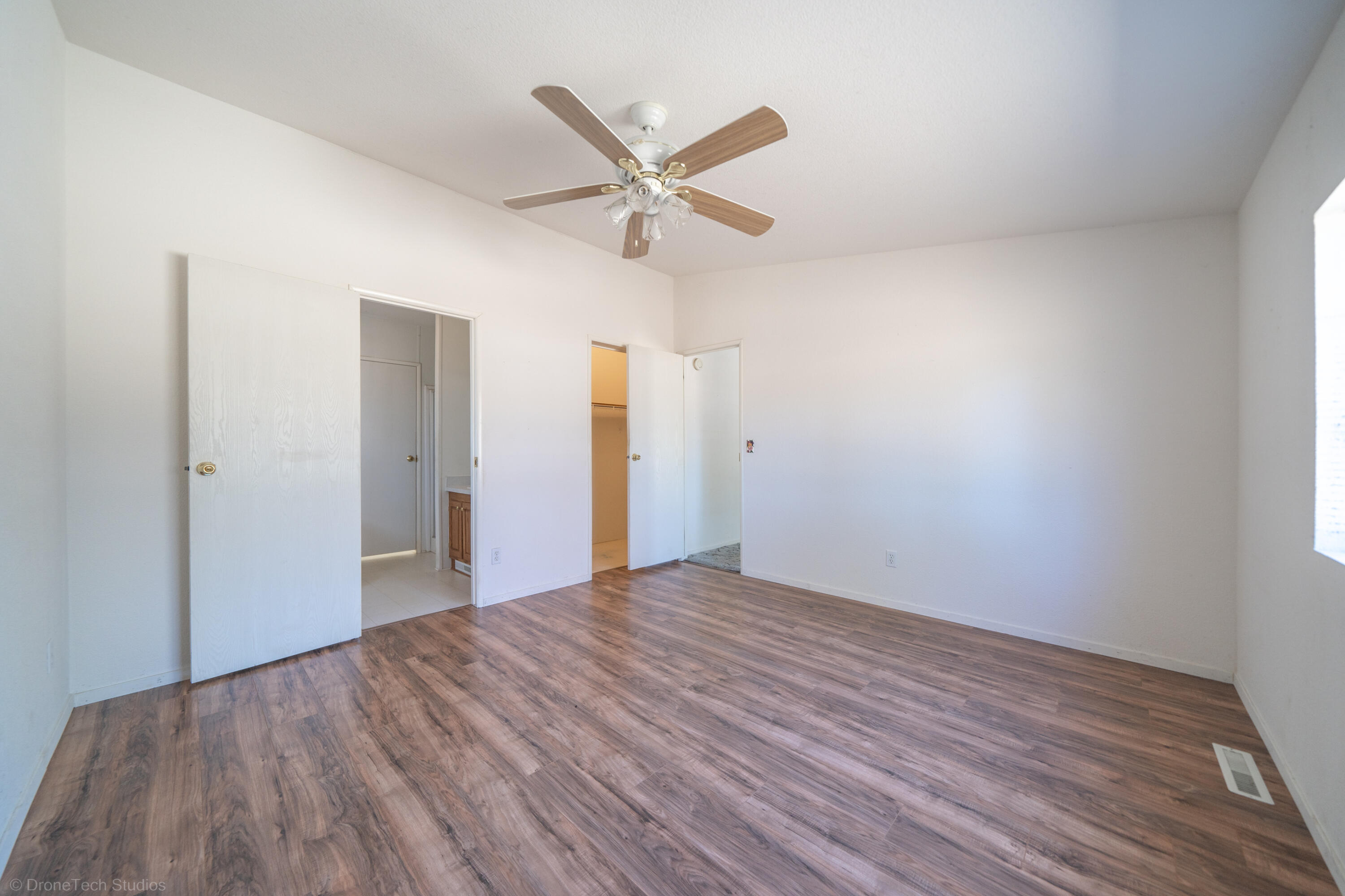 19035 Ridge Road Red Bluff, CA 96080 - Photo 28 of 74 a view of a big room with wooden floor and a ceiling fan