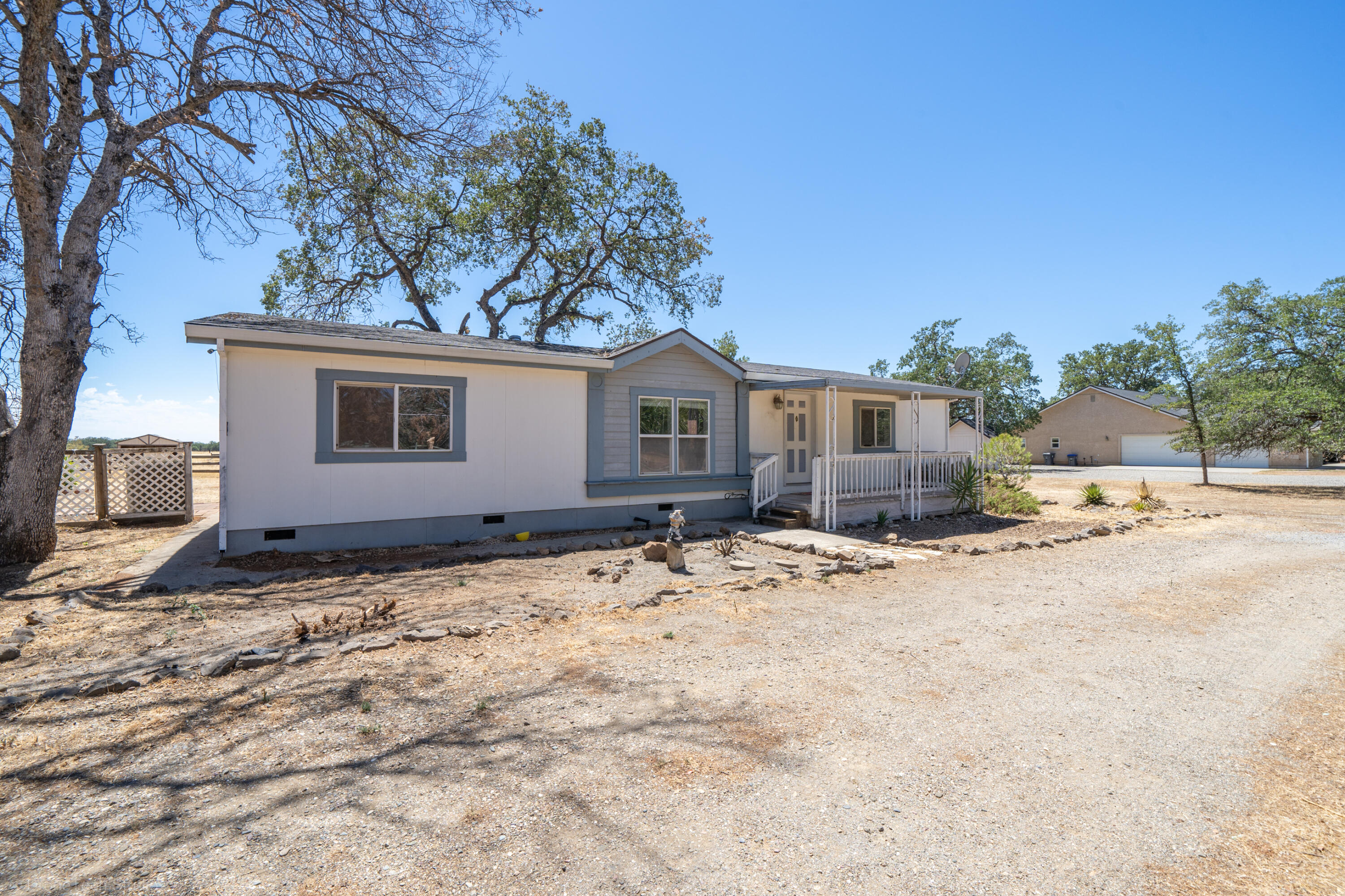 19035 Ridge Road Red Bluff, CA 96080 - Photo 5 of 74 a backyard of a house with table and chairs