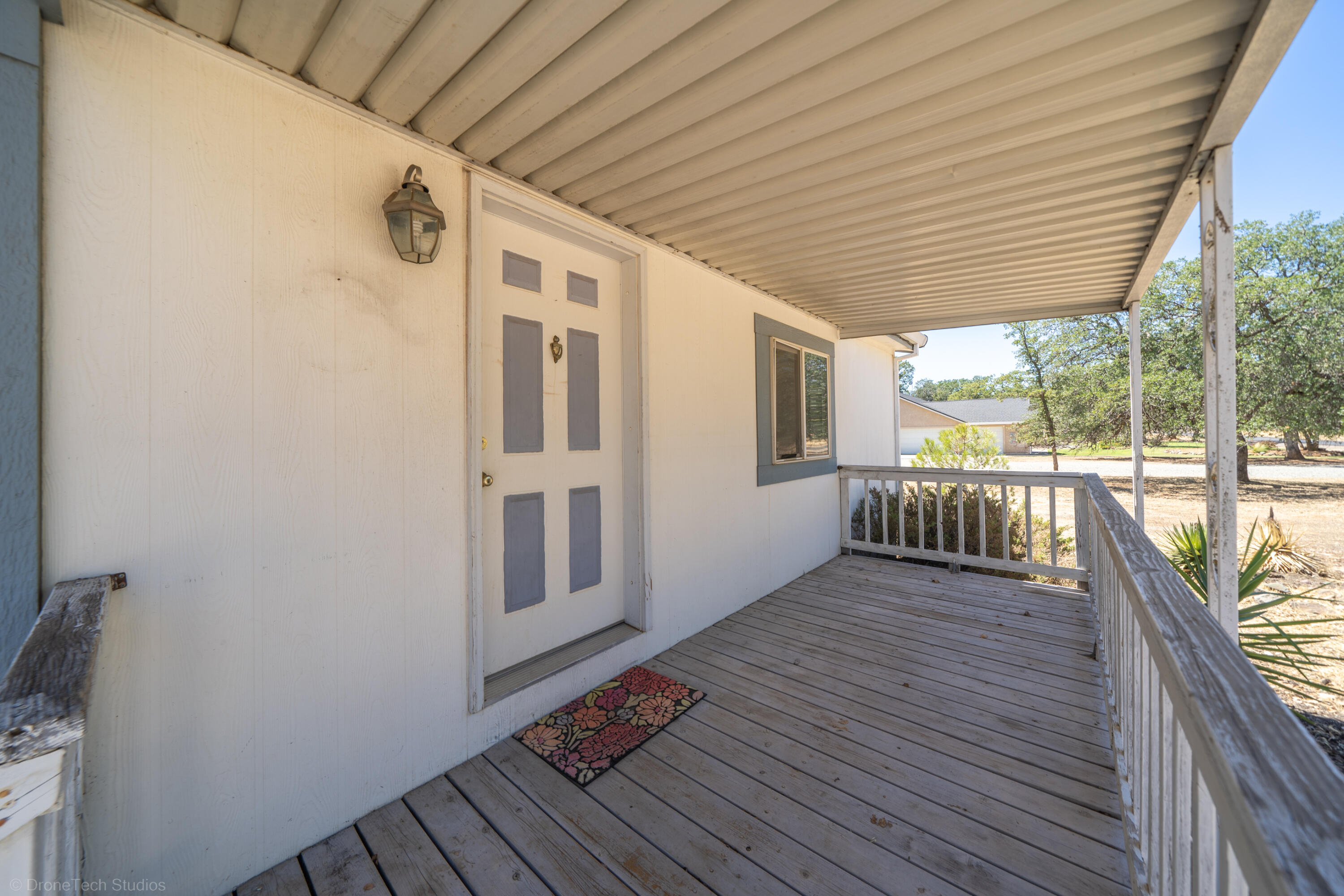 19035 Ridge Road Red Bluff, CA 96080 - Photo 7 of 74 a view of a balcony with wooden floor and iron stairs