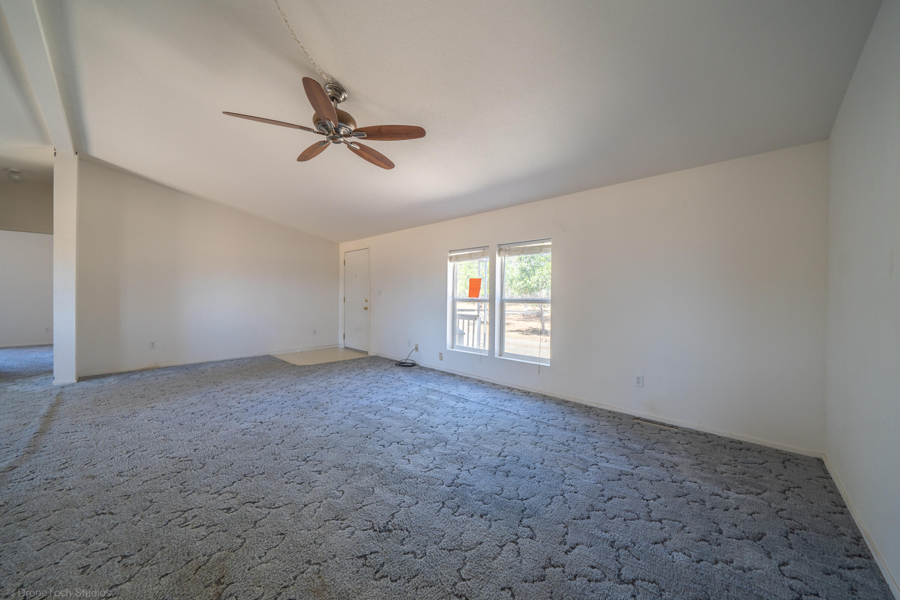 19035 Ridge Road Red Bluff, CA 96080 - Photo 9 of 74 an empty room with windows and fan
