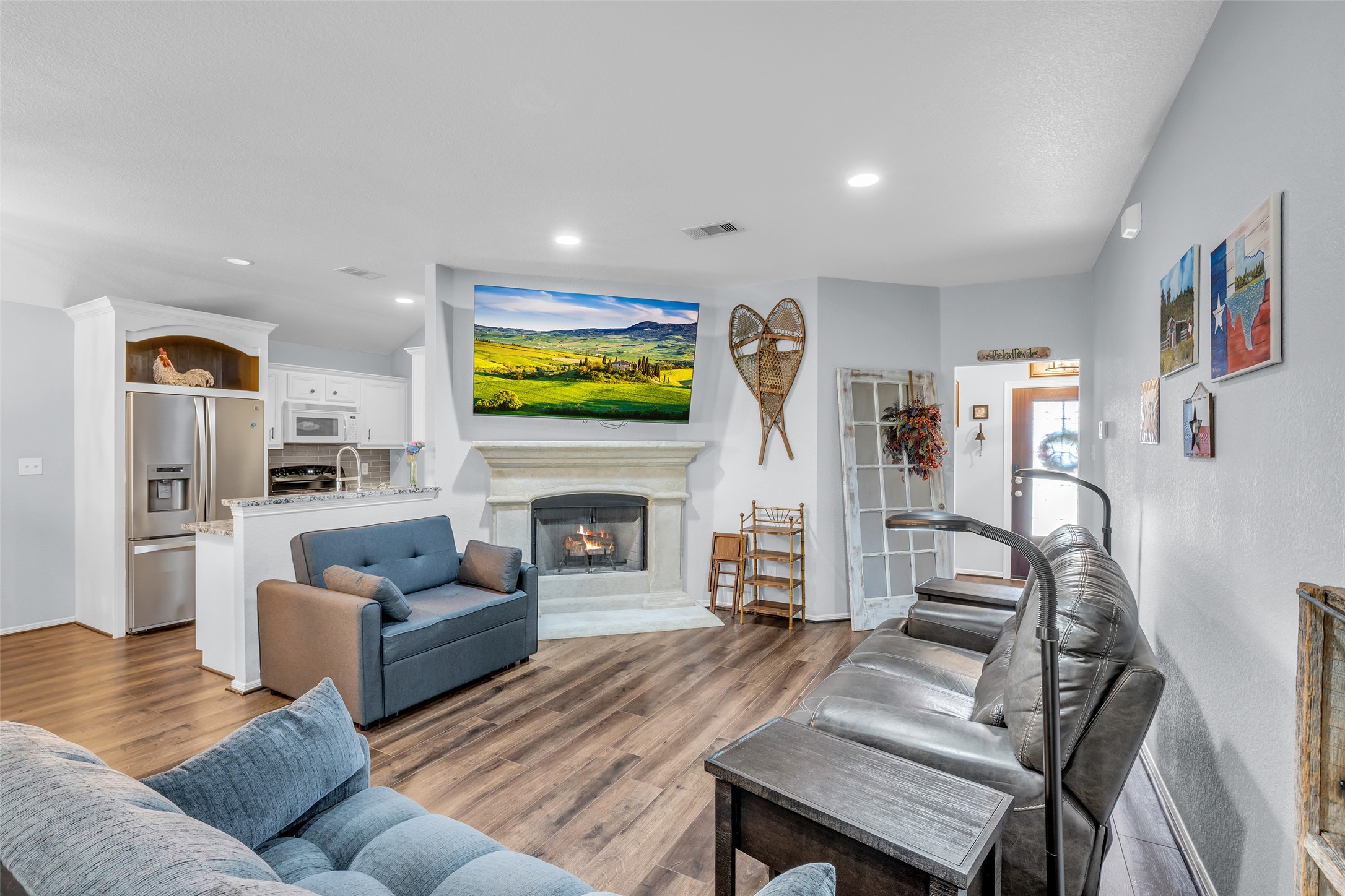 242 Sunset Path North Conroe, TX 77316 - Photo 6 of 37 Open concept living with vinyl plank flooring and tile throughout. Easy maintenance! Private and well-lit entry ahead! 242 SUNSET PATH N - Request your tour today!