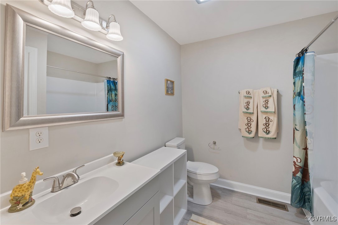 2193 Diggstown Road Bumpass, VA 23024 - Photo 23 of 33 Bathroom featuring toilet, vanity, wood finished f