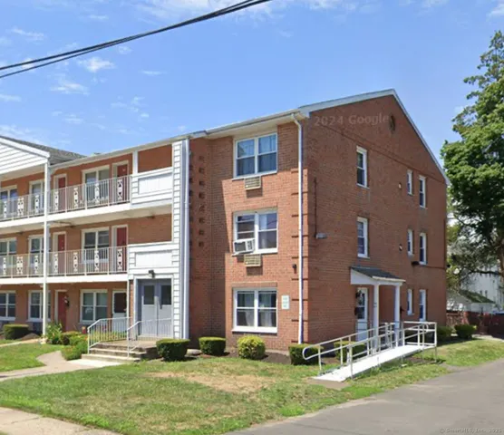 a front view of a building with a yard