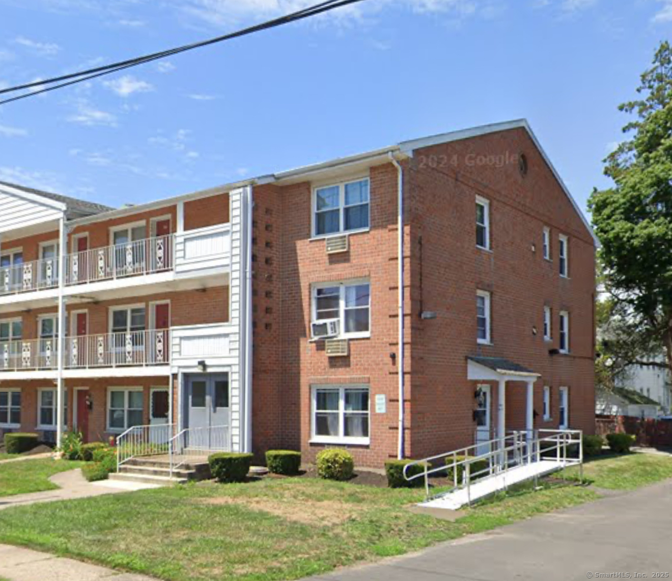 a front view of a building with a yard