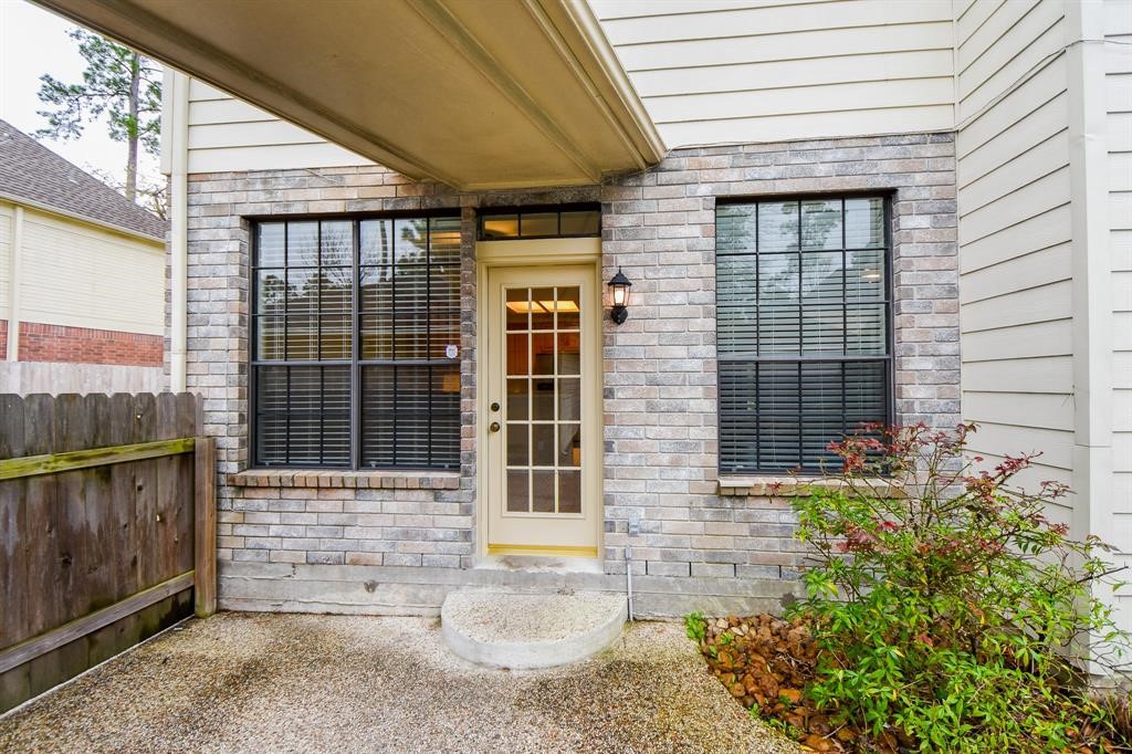 27 West Rumple Creek Place Spring, TX 77381 - Photo 28 of 32 Outside, appreciate access to the garage with a covered breezeway.