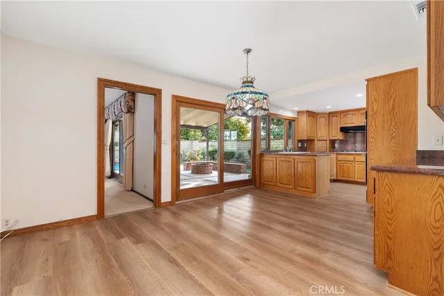 a view of a kitchen with furniture and wooden floor