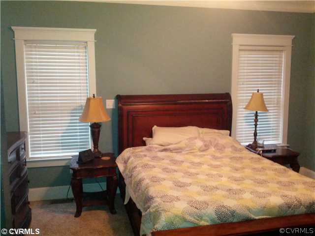 2902 Cove Ridge Trace Midlothian, VA 23112 - Photo 8 of 22 a bed sitting in a bedroom next to a window