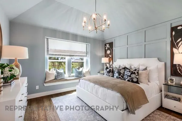 a spacious bedroom with a bed and a window
