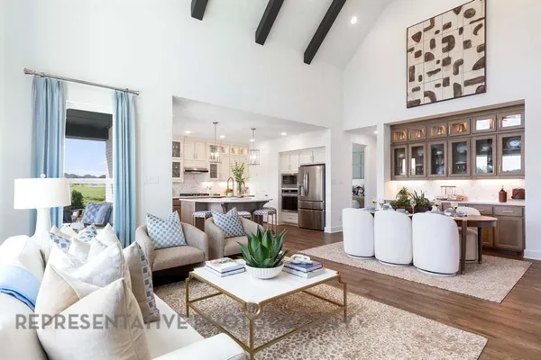 a living room with furniture and a dining table with kitchen view