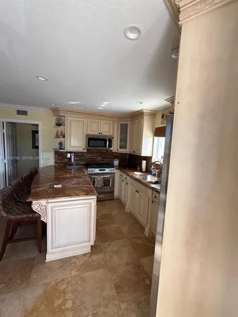 a kitchen with a stove a sink and a refrigerator
