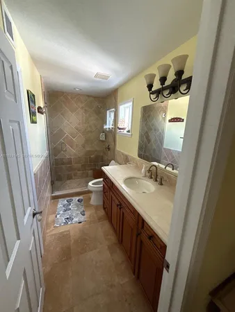 a bathroom with a sink a mirror and a shower