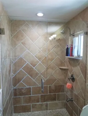 a bathroom with a shower and a mirror