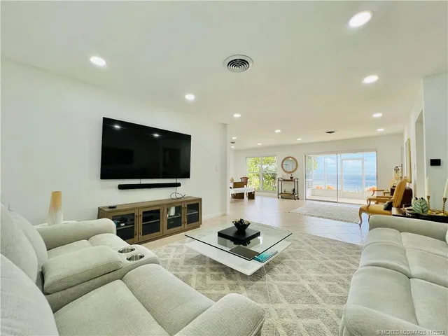a kitchen with white cabinets stainless steel appliances and window
