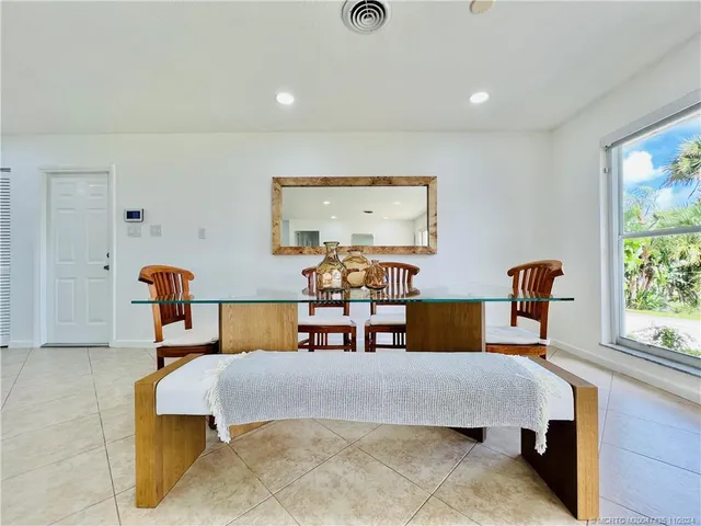 a kitchen with a refrigerator sink and white cabinets