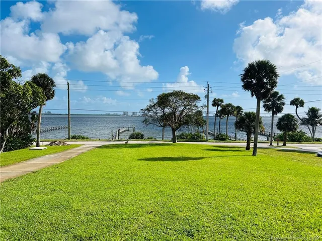 a view of a swimming pool and a yard
