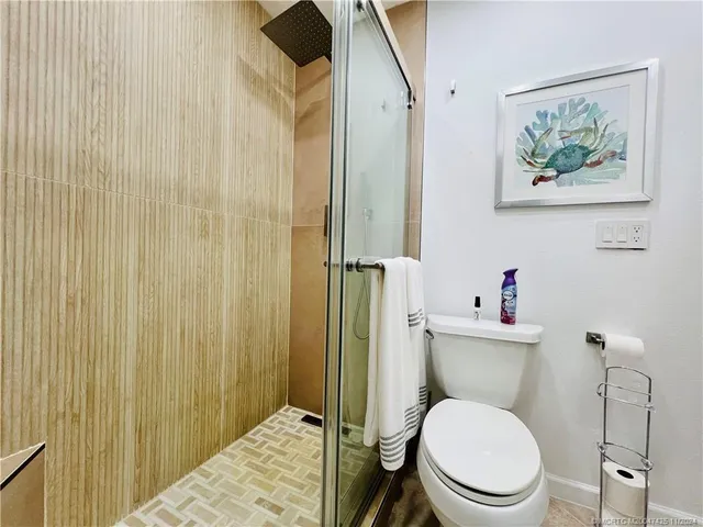 a bathroom with a toilet a sink and a shower