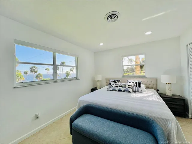 a bedroom with double bed and a window