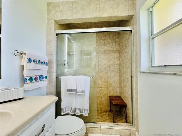 a bedroom with a bed and a lamp on table