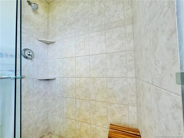 a large bed sitting in a bedroom next to a window